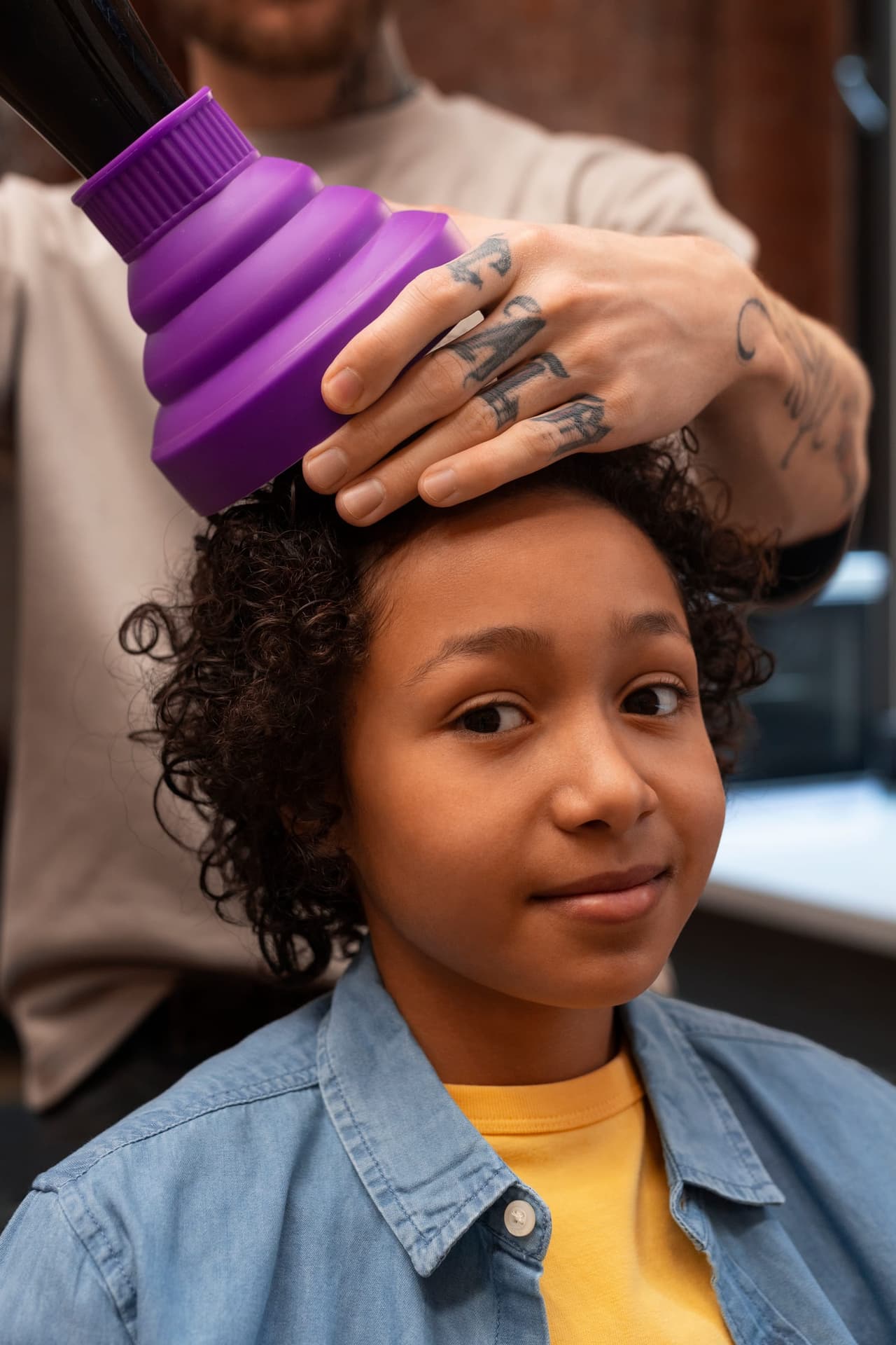 A child getting a hair touch-up in the salon