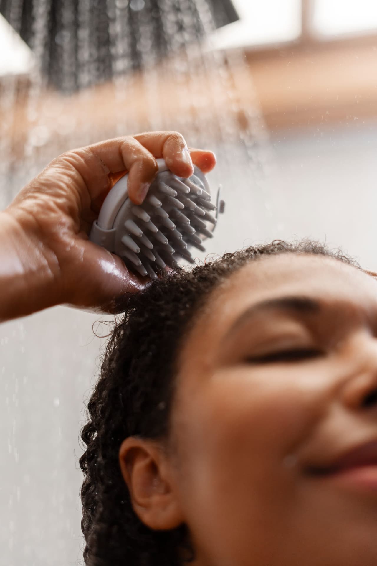 Woman washing and massaging her scalp