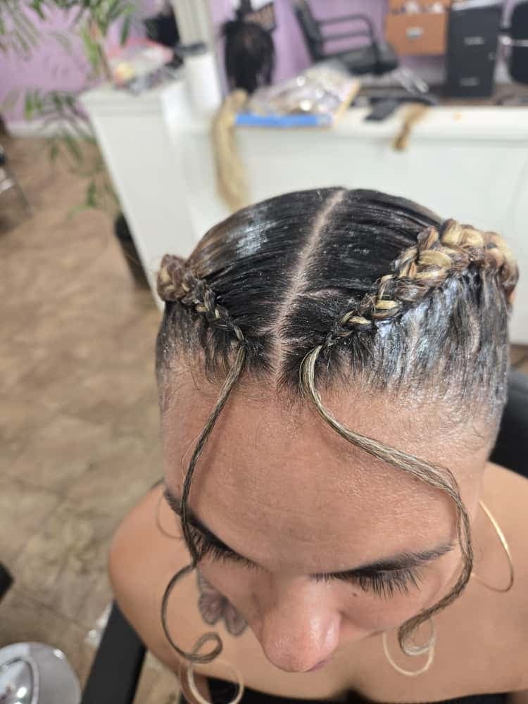 Two-cornrow style by Akwaba Hair Braiding