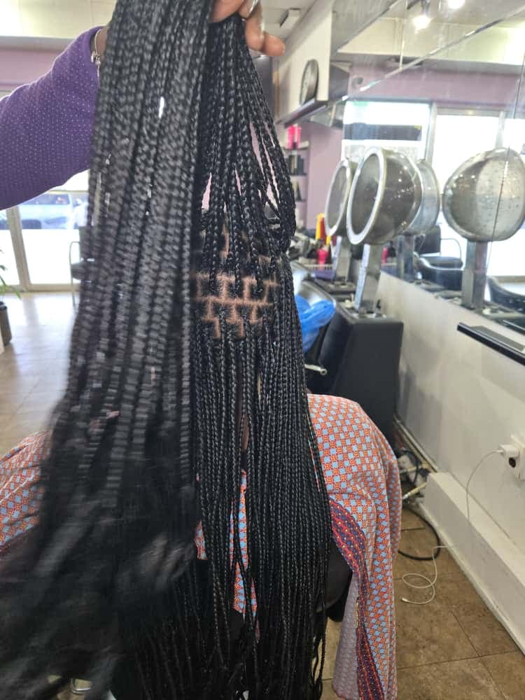 A finished knotless braids hairstyle by Akwaba Hair Braiding