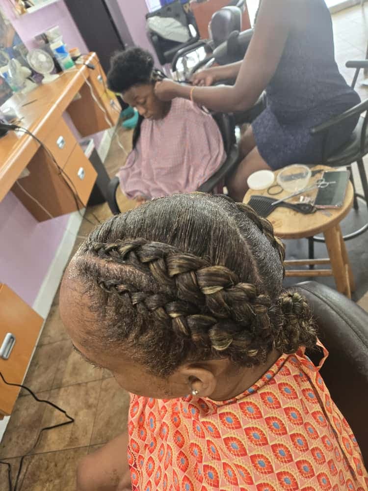 Women's cornrows by Akwaba Hair Braiding