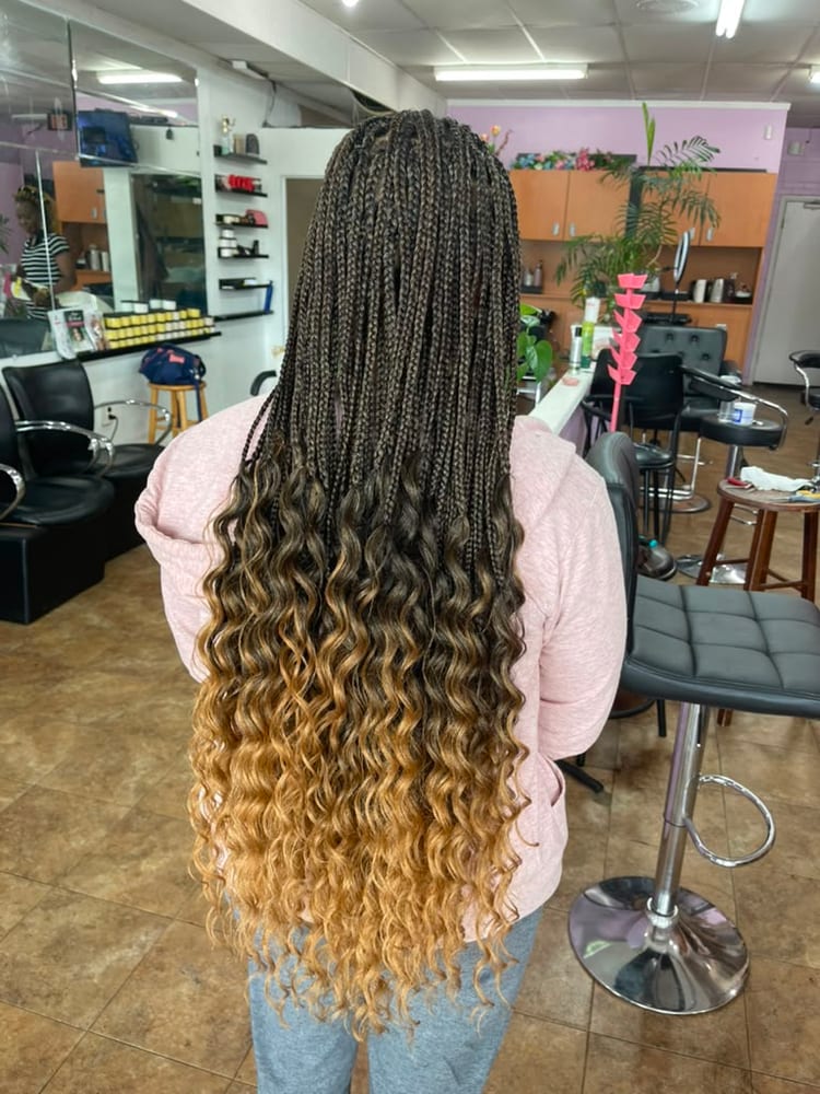 Women's french curl braids by Akwaba Hair Braiding