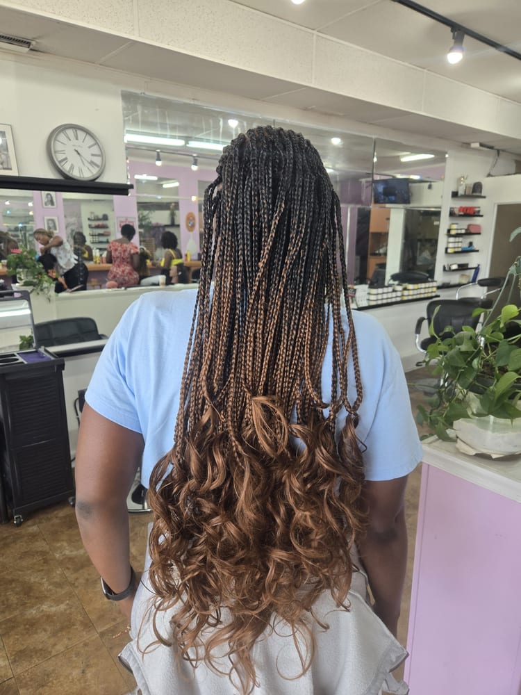 Women's french curl braids by Akwaba Hair Braiding